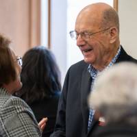 Robert Thompson shaking hands with Karen Loth.